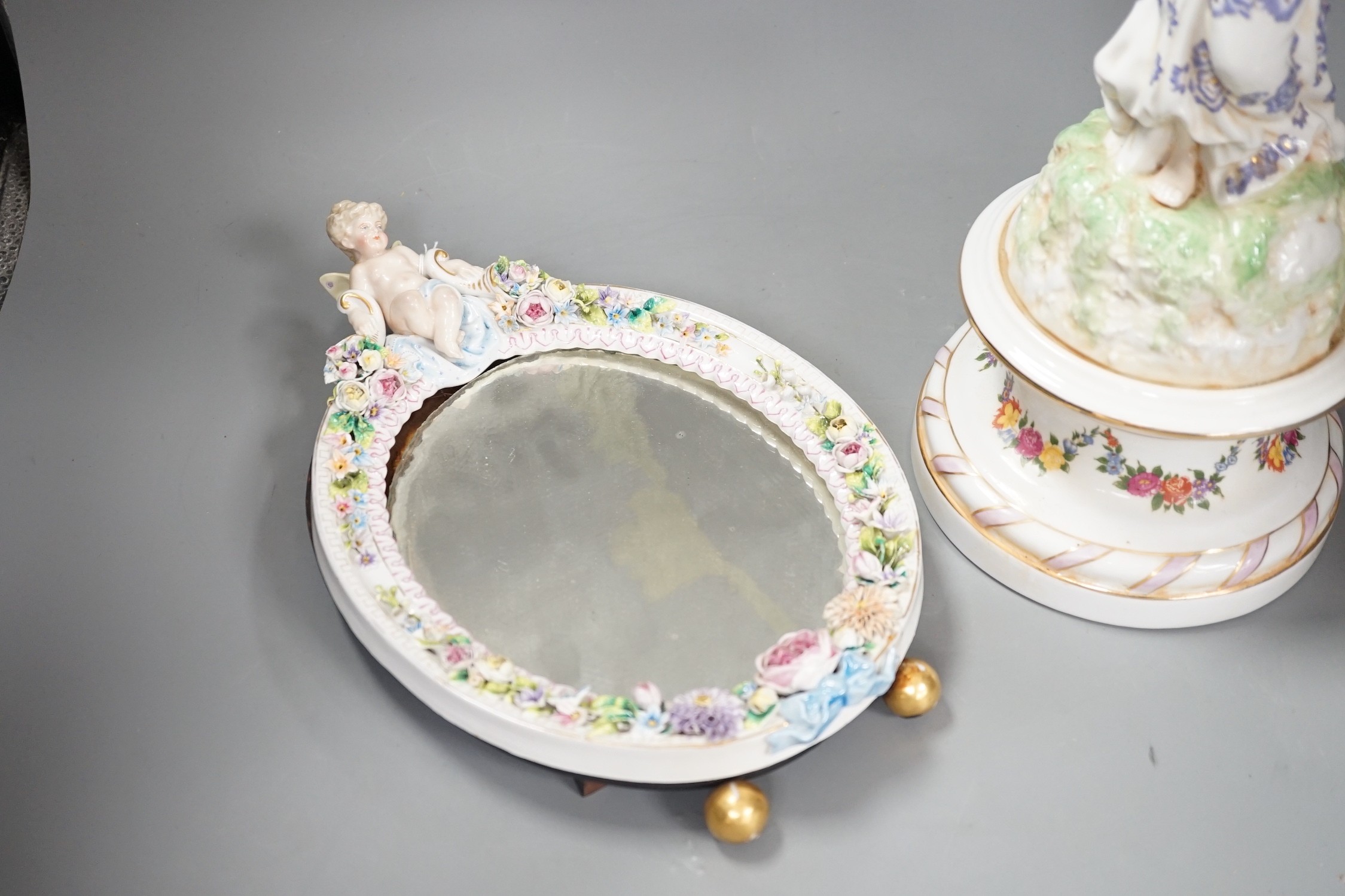 A German floral encrusted porcelain centrepiece and similar easel mirror, tallest 46cm